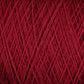 Close-up image of tightly wound JaggerSpun Maine Line 2/8 Yarn in dark red, showing its fibrous texture and overlapping strands, perfect for knitting or weaving. This mini-cone is brought to you by Jagger Brothers, Inc.