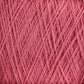 Close-up of light, pink JaggerSpun Maine Line 2/8 Yarn strands intricately wound and layered, forming a dense, crisscrossing pattern. The texture appears soft and fluffy, making it suitable for knitting or crochet projects. Bright lighting highlights the yarn's details and its vibrant color from Jagger Brothers, Inc.'s Mini-cone collection.