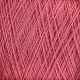 Close-up of light, pink JaggerSpun Maine Line 2/8 Yarn strands intricately wound and layered, forming a dense, crisscrossing pattern. The texture appears soft and fluffy, making it suitable for knitting or crochet projects. Bright lighting highlights the yarn's details and its vibrant color from Jagger Brothers, Inc.'s Mini-cone collection.