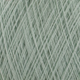 Close-up image of the JaggerSpun Maine Line 2/20 Yarn in light green, showcasing a tightly wound, crisscrossed pattern of fibers. The texture appears soft and slightly fuzzy, capturing the intricacies of individual strands woven together from medium grade wool by Jagger Brothers, Inc.