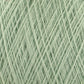 Close-up image of a ball of JaggerSpun Maine Line 2/20 Yarn from Jagger Brothers, Inc., in light green, showcasing intricate patterns formed by the crossing fibers. The yarn has a soft and fluffy texture, with individual strands clearly visible.