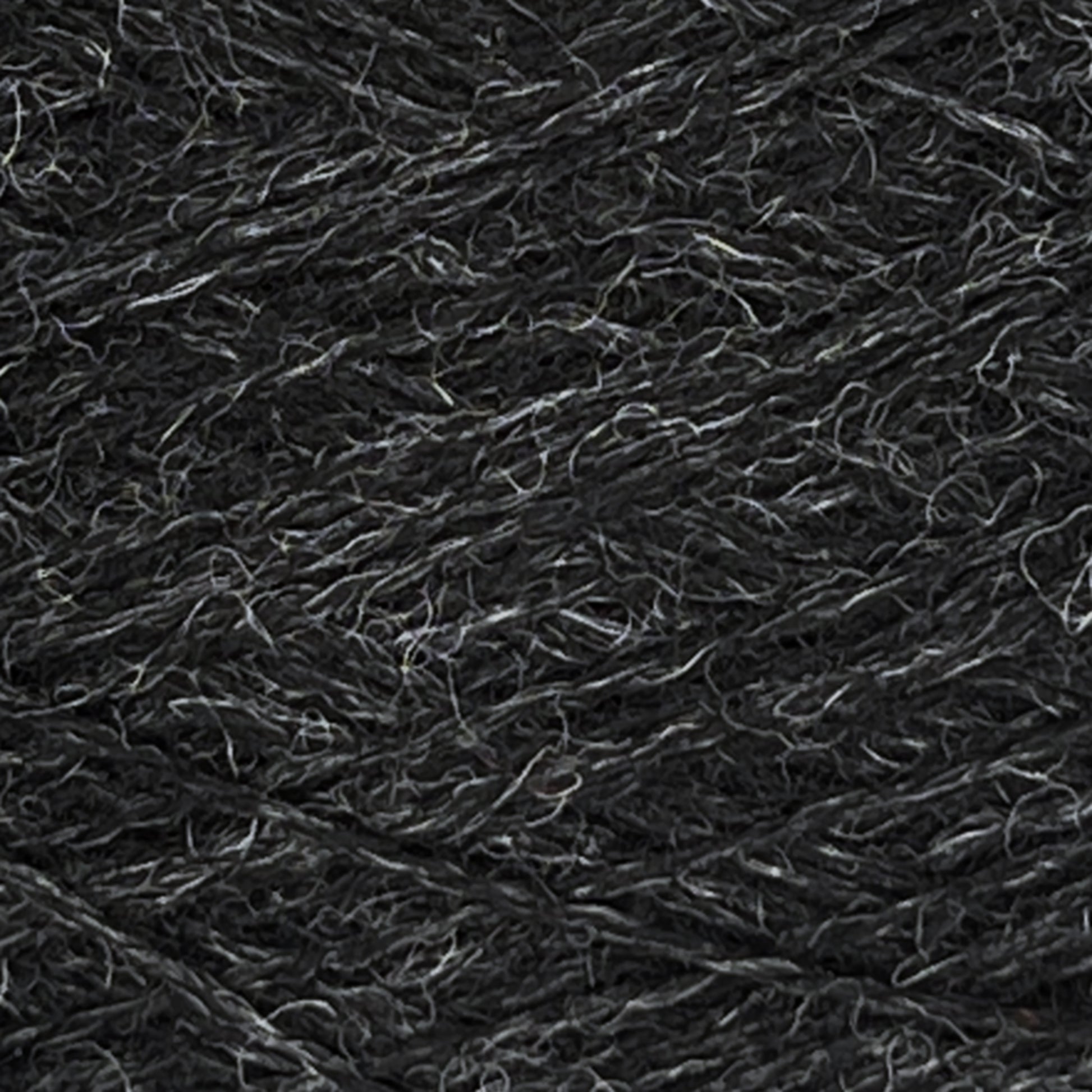 Close-up of dark grey JaggerSpun Heather 2/8 | Mini-cone yarn from Jagger Brothers, Inc., showcasing the detailed texture of twisted fibers interspersed with fine light grey threads. The intricate pattern accentuates the softness and structure of the worsted spun wool.