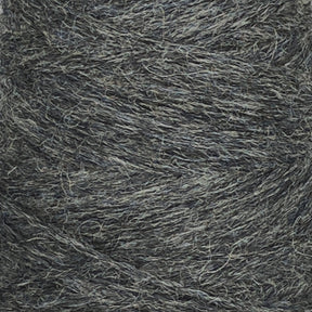 Close-up image of a mini-cone of Jagger Brothers, Inc.'s JaggerSpun Heather 2/8 yarn in greyish-green. The texture reveals a blend of fibers, with worsted spun wool providing a natural and slightly rough appearance. The yarn appears tightly wound, showcasing multiple layers of intertwined threads dyed with low-impact synthetic dyes.