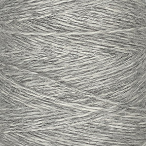 Close-up view of a spool of light gray Jagger Brothers, Inc. JaggerSpun Heather 2/8 yarn. The fingering gauge wool has a fine, slightly textured appearance, with fibers tightly wound together in a crisscross pattern around the large cone.