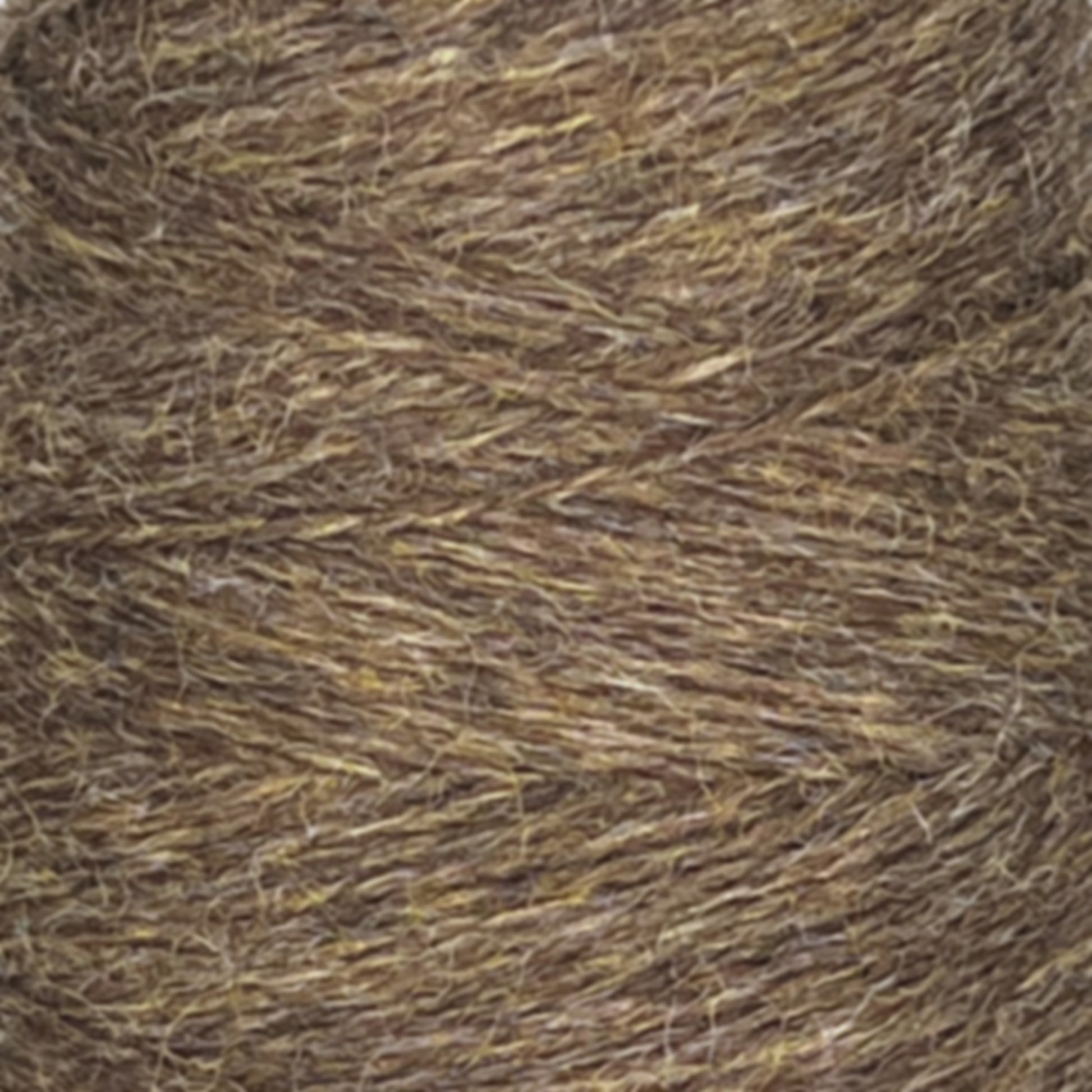 A close-up image of a spool of coarse, brown, textured JaggerSpun Heather 2/8 yarn from Jagger Brothers, Inc. The yarn appears tightly wound, with fibers in various shades of brown and hints of yellow and gray interspersed throughout. The overall texture looks rough and rustic.