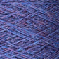 Close-up image of blue and purple Jagger Brothers, Inc. JaggerSpun Heather 2/8 mini-cone yarns wound in a crisscross pattern on a spool. The texture of the fibers and the interwoven threads are clearly visible, highlighting the intricate details of the worsted spun wool's composition.