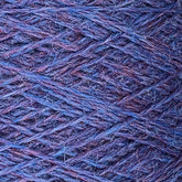 Close-up image of blue and purple Jagger Brothers, Inc. JaggerSpun Heather 2/8 mini-cone yarns wound in a crisscross pattern on a spool. The texture of the fibers and the interwoven threads are clearly visible, highlighting the intricate details of the worsted spun wool's composition.