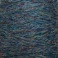 A close-up shot of JaggerSpun Heather 2/8 woolen yarn by Jagger Brothers, Inc. in shades of blue and green, showcasing its texture and intertwined fibers. The yarn appears soft and slightly fuzzy, featuring a mix of thin strands that create a rich, natural pattern. This premium material exemplifies the high quality characteristic of JaggerSpun yarns.