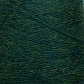 A close-up view of a spool of dark green yarn. The JaggerSpun Heather 2/8 Mini-cone from Jagger Brothers, Inc. is tightly wound, showcasing its texture and slight fuzziness. The image highlights the various shades of green within the wool, dyed using low-impact synthetic dyes for an eco-friendly touch.