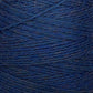 Close-up image of a spool of blue yarn reveals the intricate texture and individual strands wrapped around the spool. The yarn appears slightly fuzzy, showcasing a mix of darker and lighter blue fibers. Crafted from JaggerSpun Heather 2/8 Mini-cone by Jagger Brothers, Inc., it highlights fine detail and artisanal quality.