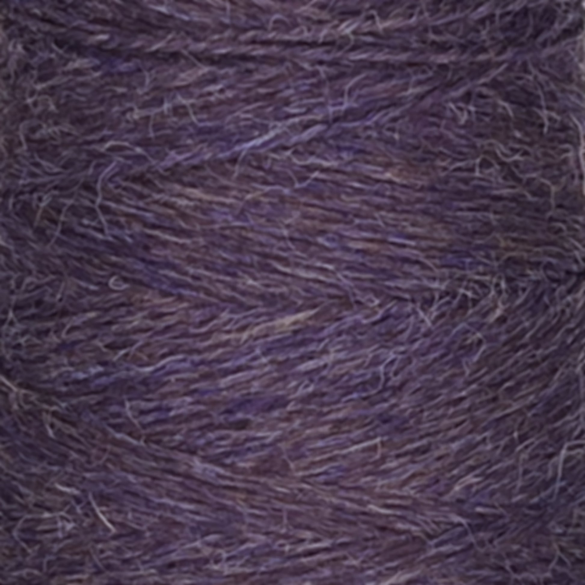 A close-up of a spool of Jagger Brothers, Inc.'s JaggerSpun Heather 2/8 yarn in purple. The texture is clearly visible, showing the intertwined fibers and subtle variations in the purple hue, created using low-impact synthetic dyes for a slightly heathered appearance. The yarn looks soft and slightly fuzzy.