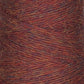 A close-up image of a spool of JaggerSpun Heather 2/8 | Mini-cone by Jagger Brothers, Inc. The yarn displays a mixed color pattern with shades of red, orange, and a hint of purple. Its texture appears soft and slightly fuzzy, with strands tightly wound together and dyed using low-impact synthetic dyes.