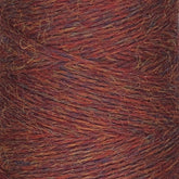 A close-up image of a spool of JaggerSpun Heather 2/8 | Mini-cone by Jagger Brothers, Inc. The yarn displays a mixed color pattern with shades of red, orange, and a hint of purple. Its texture appears soft and slightly fuzzy, with strands tightly wound together and dyed using low-impact synthetic dyes.