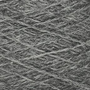 Close-up of a ball of JaggerSpun Heather 2/8 Mini-cone yarn from Jagger Brothers, Inc. The texture is coarse, with visible fibers and intricately wound strands in a criss-cross pattern. The color is a muted, medium gray, and the surface appears slightly fuzzy.