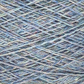 Close-up image of a ball of Jagger Brothers, Inc.'s JaggerSpun Heather 2/8 Mini-cone yarn, showcasing a mix of blue, green, and purple colors intertwined. The texture of the yarn is clearly visible, revealing the intricate and crisscrossing patterns of the fibers crafted with low-impact synthetic dyes.