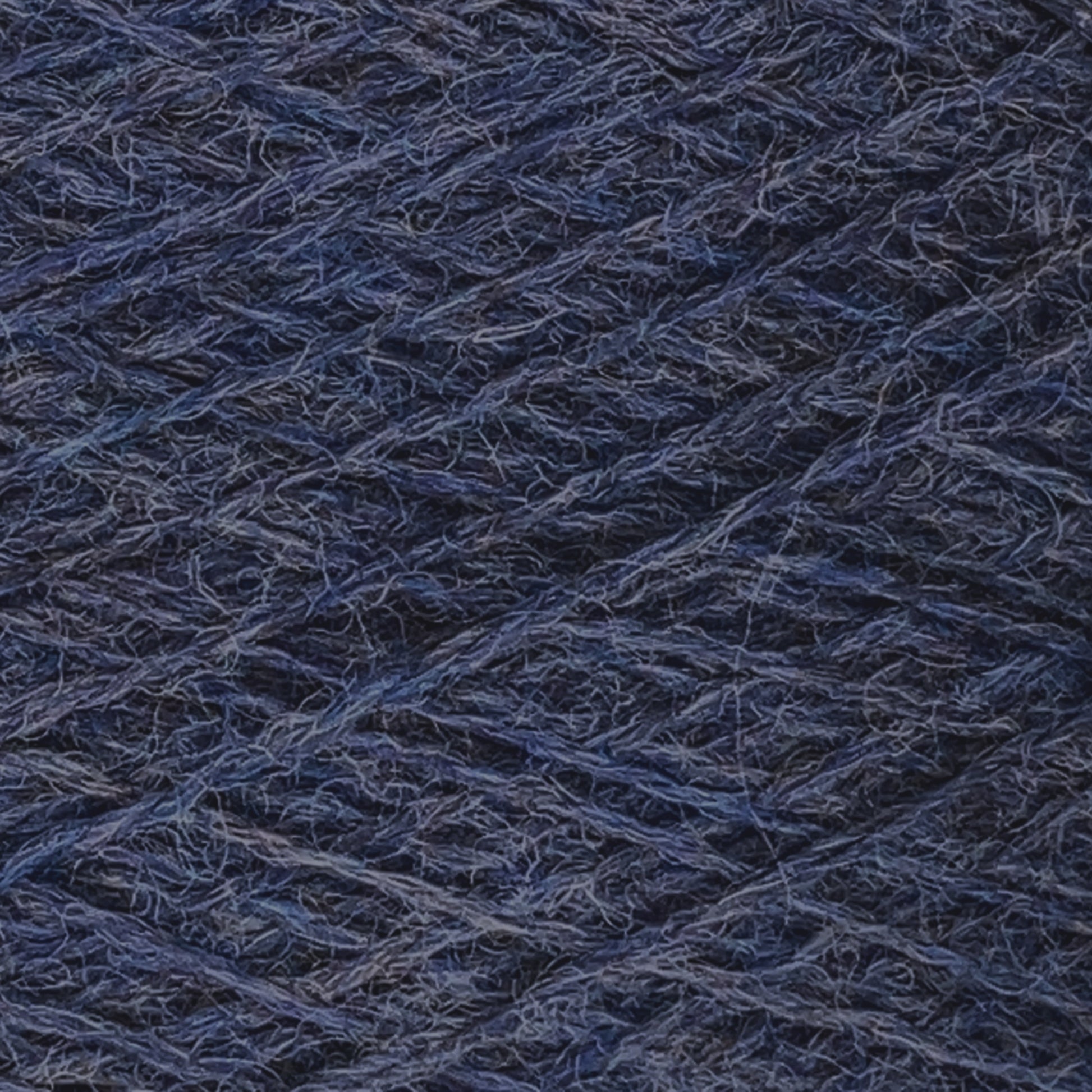 Close-up image of dark blue JaggerSpun Heather 2/8 Mini-cone yarns from Jagger Brothers, Inc. wound tightly in a crisscross pattern, highlighting the texture and detailed fibers.