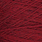 Close-up image of a ball of red yarn. The Jagger Brothers, Inc. JaggerSpun Heather 2/8 Mini-cone yarns are tightly wound, showcasing a detailed texture with strands of various shades of red intertwined.