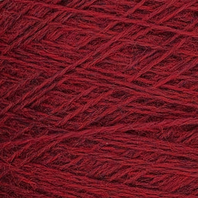 Close-up image of a ball of red yarn. The Jagger Brothers, Inc. JaggerSpun Heather 2/8 Mini-cone yarns are tightly wound, showcasing a detailed texture with strands of various shades of red intertwined.