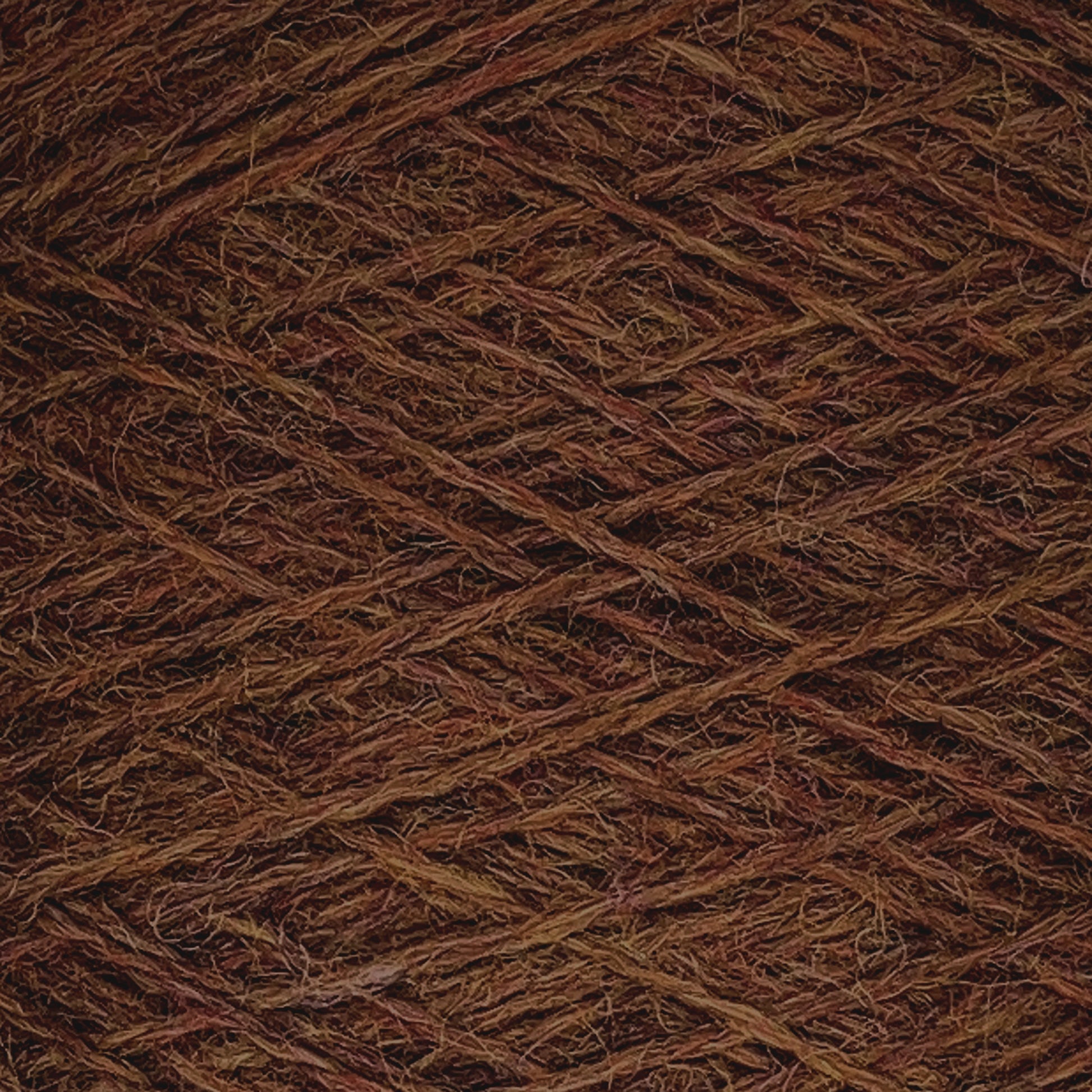 Close-up of dense, interwoven strands of JaggerSpun Heather 2/8 yarns by Jagger Brothers, Inc. The fingering gauge wool displays varying shades of brown, creating a textured pattern. It appears to be tightly wound, showcasing the intricate details and fibers of this worsted spun material on a large cone.