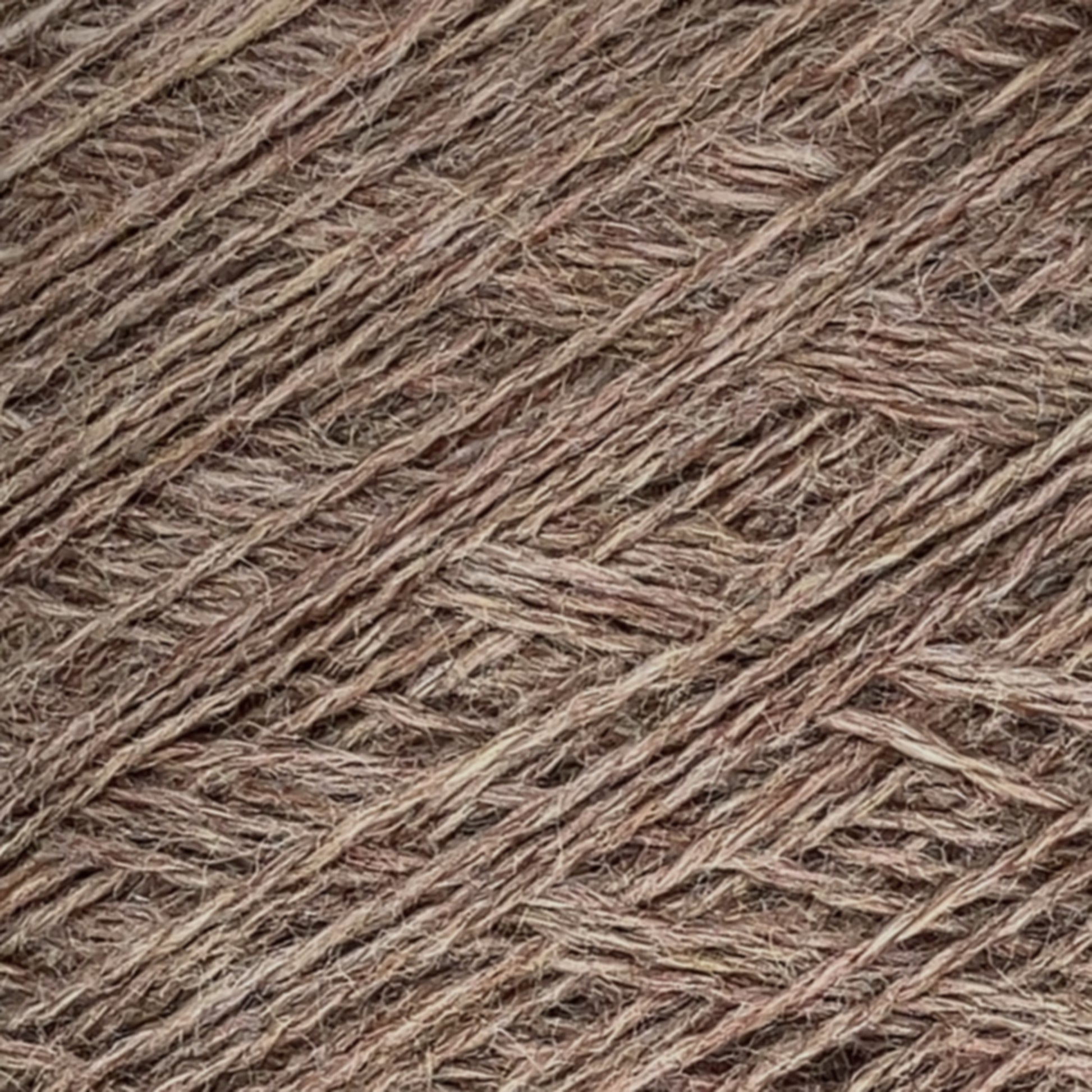 A close-up view of brown jute twine wrapped tightly in an overlapping pattern, creating a textured and fibrous appearance. The strands are visibly intertwined, forming a dense and intricate network reminiscent of Jagger Brothers' JaggerSpun Heather 2/8 Mini-cone yarns.