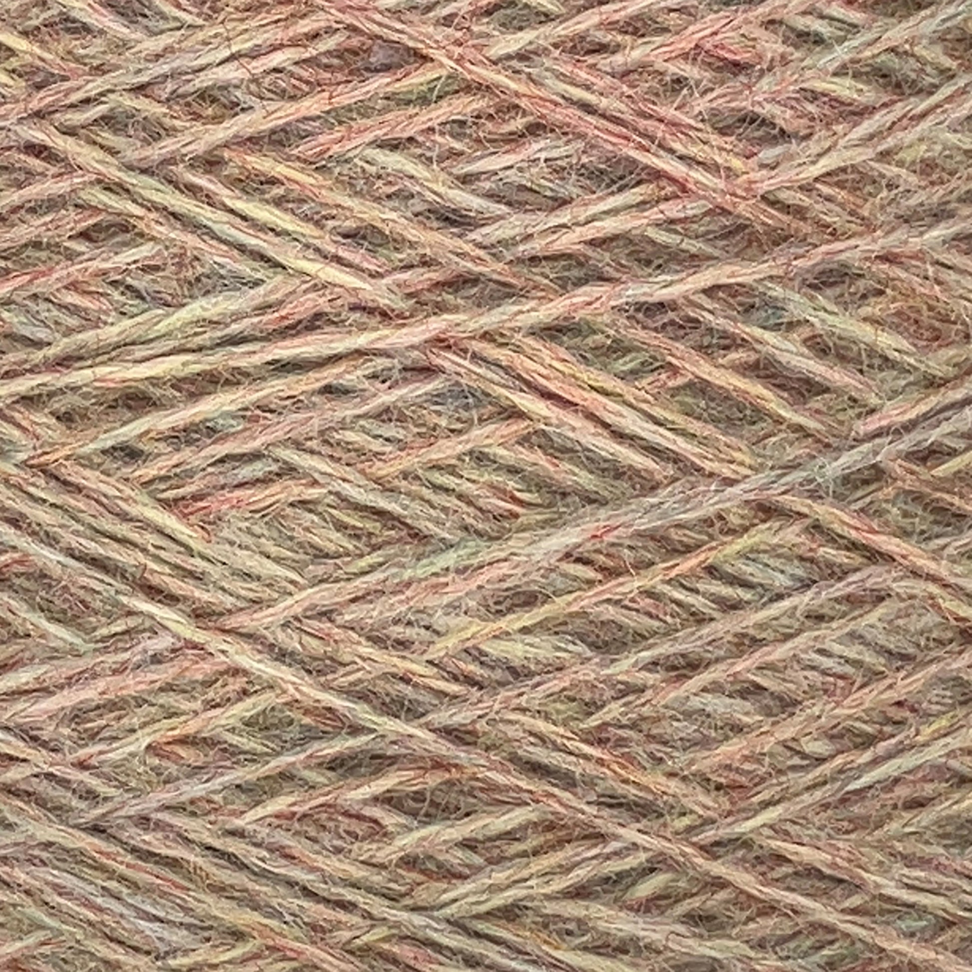 Close-up view of tangled multicolored JaggerSpun Heather 2/8 yarns in shades of beige, brown, and subtle hints of green and red, creating a textured pattern.