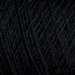 Close-up image of tightly wound dark grey JaggerSpun Superfine Merino 2/18 Yarn | Mini-cone by Jagger Brothers, Inc., featuring a soft texture and forming a dense, crisscross pattern. The fibers appear smooth and slightly fuzzy, with a subtle color gradient ranging from deep charcoal to lighter grey tones—ideal for hand knitters' projects.