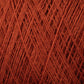 Close-up image of a JaggerSpun Superfine Merino 2/18 Yarn large cone by Jagger Brothers, Inc. The texture of the yarn strands is clearly visible, showcasing crisscrossed threads that form a detailed pattern. Made from superfine merino wool, the vivid red color stands out prominently. The soft fibers add a tactile element to the image that hand knitters will appreciate.