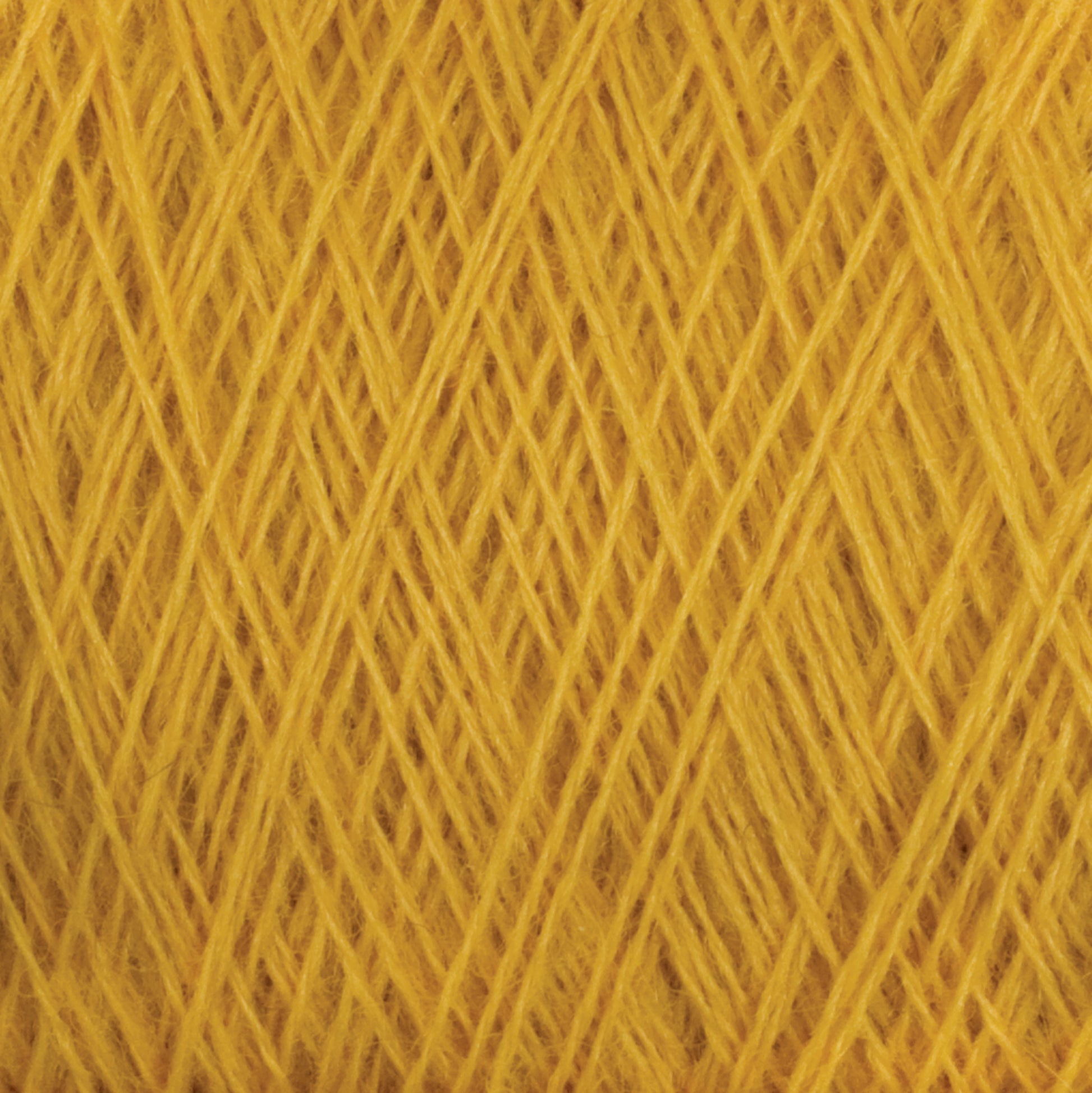 Close-up view of a large cone of JaggerSpun Superfine Merino 2/18 Yarn from Jagger Brothers, Inc. in vibrant yellow, showcasing a crisscross pattern of fibers. The texture is soft and fibrous, highlighting the detailed interwoven threads ideal for hand knitters.