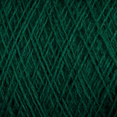 A close-up image of the JaggerSpun Superfine Merino 2/18 Yarn in green, showing intricate crisscrossing fibers and textured patterns. The yarn, produced by Jagger Brothers, Inc., appears to be tightly wound, highlighting the detailed and uniform structure of the threads. This large cone is perfect for hand knitters seeking quality material.