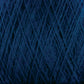 Close-up view of dark blue JaggerSpun Superfine Merino 2/18 Yarn | Mini-cone available from Jagger Brothers, Inc., wound tightly into a ball. The yarn strands create a criss-cross pattern, showcasing various shades of blue. The texture appears soft and slightly fuzzy, typical of high-quality Merino wool yarn.