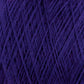 Close-up of a ball of deep purple JaggerSpun Superfine Merino 2/18 Yarn from Jagger Brothers, Inc. The texture of the yarn is clearly visible, with individual strands interwoven to create a dense, fibrous pattern.