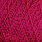 Close-up image of a ball of bright pink JaggerSpun Superfine Merino 2/18 Yarn from Jagger Brothers, Inc., with threads woven tightly together forming a crisscross pattern. The texture appears soft and slightly fuzzy, indicating the yarn is made of superfine Merino wool.