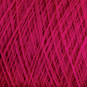 Close-up image of a ball of bright pink JaggerSpun Superfine Merino 2/18 Yarn from Jagger Brothers, Inc., with threads woven tightly together forming a crisscross pattern. The texture appears soft and slightly fuzzy, indicating the yarn is made of superfine Merino wool.