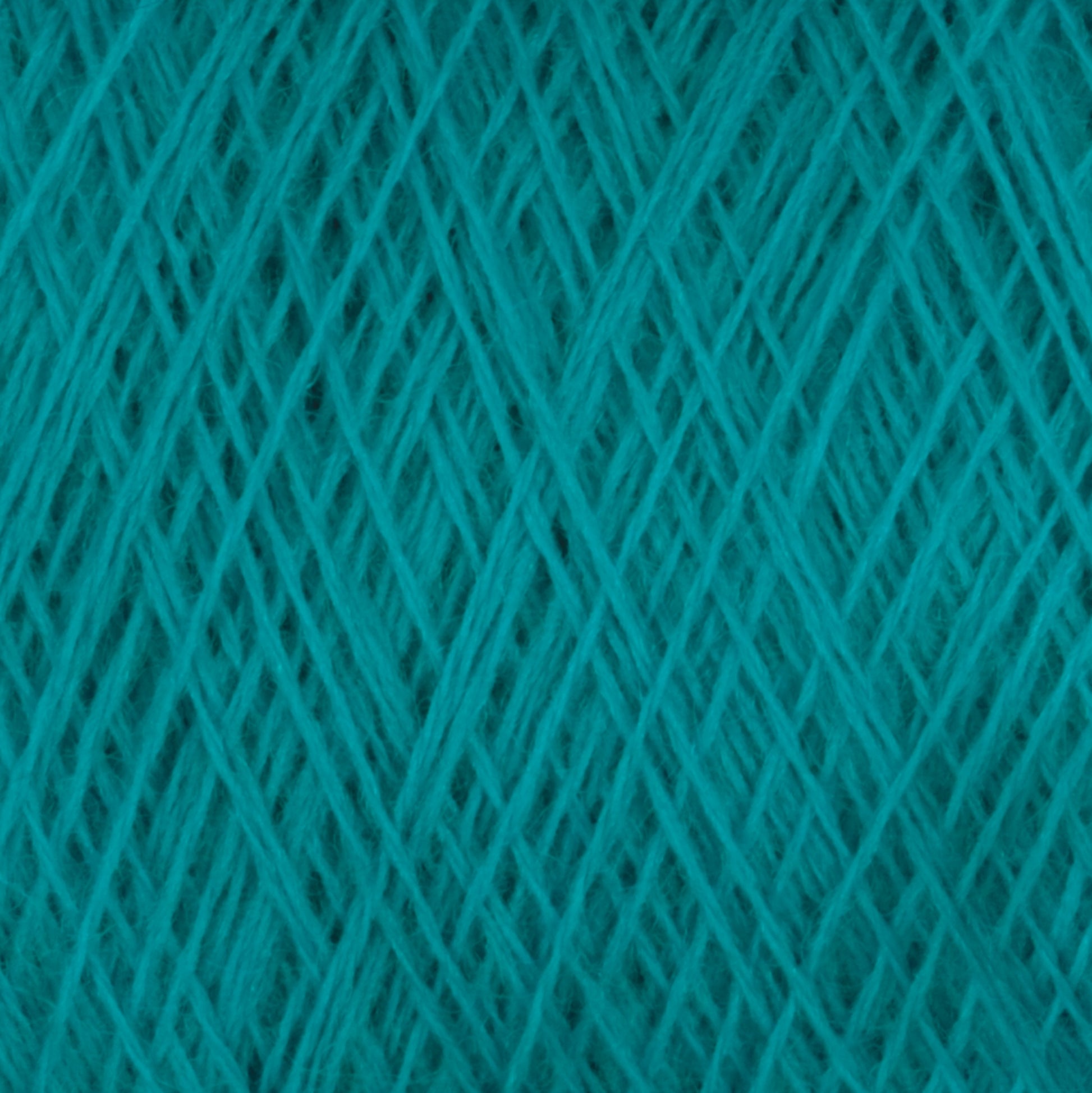 Close-up image of Jagger Brothers, Inc.'s JaggerSpun Superfine Merino 2/18 Yarn in turquoise, wound into a ball. The detailed pattern of intersecting and overlapping strands is ideal for hand knitters crafting with worsted weight.