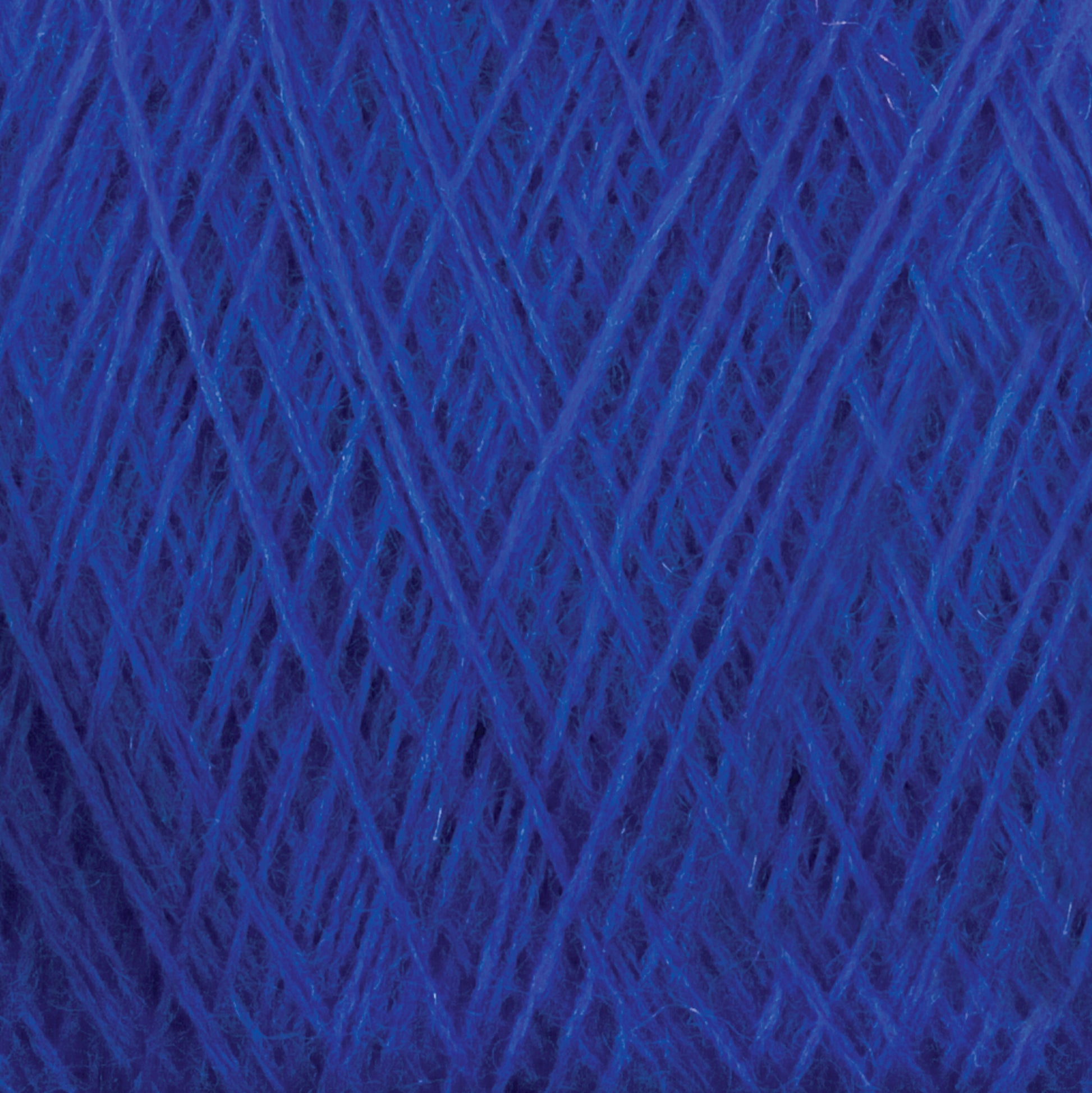 Close-up of JaggerSpun Superfine Merino 2/18 Yarn by Jagger Brothers, Inc., in a deep blue shade, showcasing the intricate crisscrossing threads and soft texture. The yarn’s rich color and detailed fibrous strands are prominently displayed, highlighting its worsted spun quality.