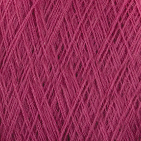 Close-up of JaggerSpun Superfine Merino 2/18 Yarn wound tightly in a crisscross pattern, highlighting the texture of the merino wool fibers and intricate overlapping strands. The yarn, available in varying shades of pink due to the lighting, has a soft, fuzzy appearance. Perfect for hand knitters, this large cone from Jagger Brothers, Inc. is ideal for any project.