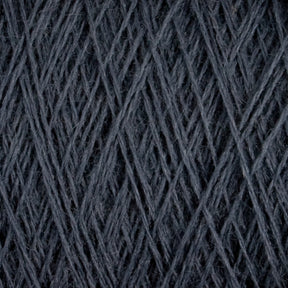 Close-up image of dark grey JaggerSpun Superfine Merino 2/18 Yarn by Jagger Brothers, Inc., wound tightly in a mini-cone, showcasing the intricate crisscross pattern of the fibers. The texture appears soft and slightly fuzzy, highlighting the fibrous nature of this hand knitters yarn.