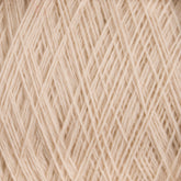 Close-up view of JaggerSpun Superfine Merino 2/18 Yarn | Mini-cone strands crossed and interwoven, forming a tightly packed and textured pattern. The worsted spun yarn fibers from Jagger Brothers, Inc. appear soft and slightly fuzzy, creating a complex and intricate design perfect for hand knitters.