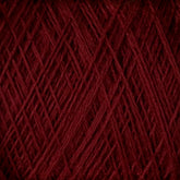 A close-up image of the JaggerSpun Superfine Merino 2/18 Yarn from Jagger Brothers, Inc., in burgundy, tightly wrapped in a crisscross pattern. The detailed texture showcases the individual fibers and the rich, deep color of this worsted weight yarn, ideal for hand knitters seeking premium materials.