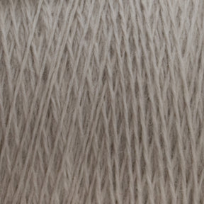 A close-up image of JaggerSpun Superfine Merino 2/18 Yarn | Mini-cone fibers from Jagger Brothers, Inc., tightly wound together, displaying the texture and strands in a crisscross pattern. The yarn appears soft and slightly fuzzy, ideal for hand knitters seeking quality material.