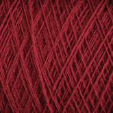 Close-up image of luxurious deep red JaggerSpun Zephyr Wool-Silk 2/18 Yarn wound tightly in a ball, showing the texture and fibrous strands intertwined in a crisscross pattern from Jagger Brothers, Inc.