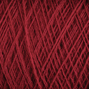 Close-up image of luxurious deep red JaggerSpun Zephyr Wool-Silk 2/18 Yarn wound tightly in a ball, showing the texture and fibrous strands intertwined in a crisscross pattern from Jagger Brothers, Inc.