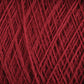 Close-up image of a luxurious JaggerSpun Zephyr Wool-Silk 2/18 Yarn | Mini-cone in deep red, with individual strands intricately wound in a crisscross pattern. The texture appears soft and slightly fuzzy. This exquisite yarn is crafted by Jagger Brothers, Inc.