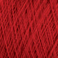 Close-up of a tightly wound spool of JaggerSpun Zephyr Wool-Silk 2/18 Yarn from Jagger Brothers, Inc., showcasing the intricate and crisscrossing fibers. The texture is prominent, with individual strands visible, highlighting the detailed weave and vibrant color on this large cone.