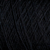 Close-up of JaggerSpun Zephyr Wool-Silk 2/18 Yarn by Jagger Brothers, Inc., showcasing its black yarn with a visible texture and interwoven strands forming a crisscross pattern. The slightly fuzzy surface highlights the luxurious fibrous nature of this premium blend, combining fine silk with Australian merino wool for unparalleled softness and quality in this large cone format.