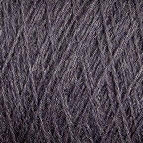 Close-up of a textured surface showing tightly woven, dark gray yarn. The intricate crisscross pattern and soft fibers are clearly visible, highlighting the detailed craftsmanship and material quality of this luxurious JaggerSpun Zephyr Wool-Silk 2/18 Yarn from Jagger Brothers, Inc.