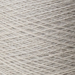 Close-up image of a spool of Jagger Brothers, Inc.'s JaggerSpun Zephyr Wool-Silk 2/18 Yarn in light gray. The fibers, made from luxurious Australian merino wool blended with silk, are tightly wound in a crisscross pattern, showcasing the texture and slight variations in color.