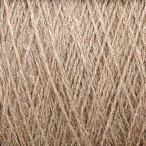 Close-up image of JaggerSpun Zephyr Wool-Silk 2/18 Yarn by Jagger Brothers, Inc. in beige, showcasing tightly interwoven fibers forming a textured, crisscross pattern. The natural wool and silk fibers appear sophisticated and slightly lustrous, blending the luxurious qualities of high-end yarn with an intricately detailed design.