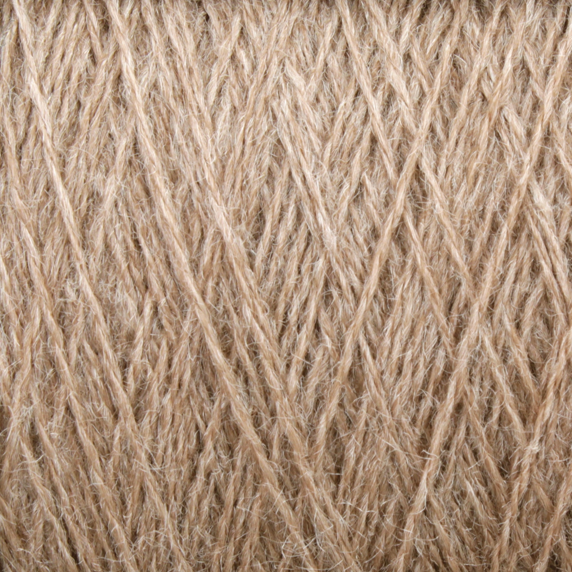 Close-up of beige yarn fibers intertwined in a textured pattern. The strands have a slightly rough appearance, indicating the JaggerSpun Zephyr Wool-Silk 2/18 Yarn from Jagger Brothers, Inc. The image captures the intricate details and texture of this luxurious yarn.