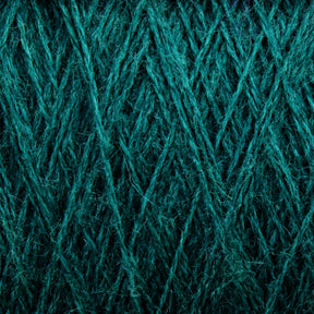 Close-up of the intricate texture of a teal-colored JaggerSpun Zephyr Wool-Silk 2/18 Yarn | Mini-cone by Jagger Brothers, Inc. The fibers are tightly woven with crisscrossing patterns, creating a rich, detailed surface. The vibrant color enhances the texture, making this luxurious yarn appear both soft and sturdy.